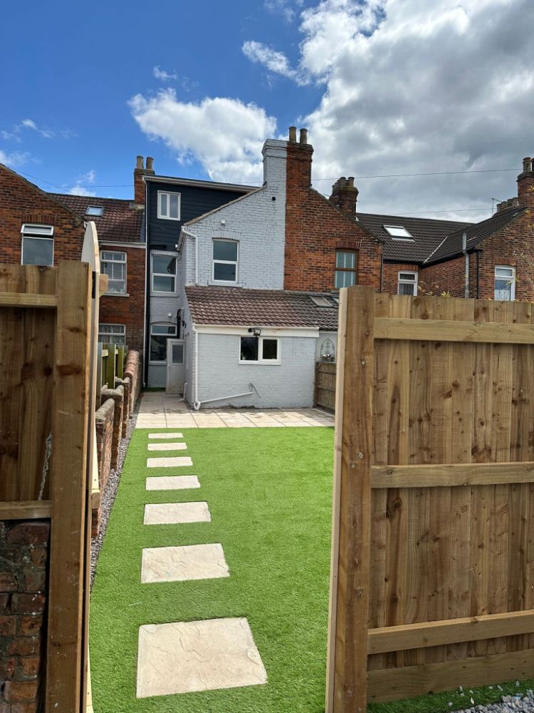 Fence installation and paving stone placement by Construction Edge